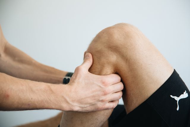 Physical therapist working on injured knee